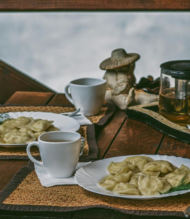Beautiful wooden table with tea cup and herbs